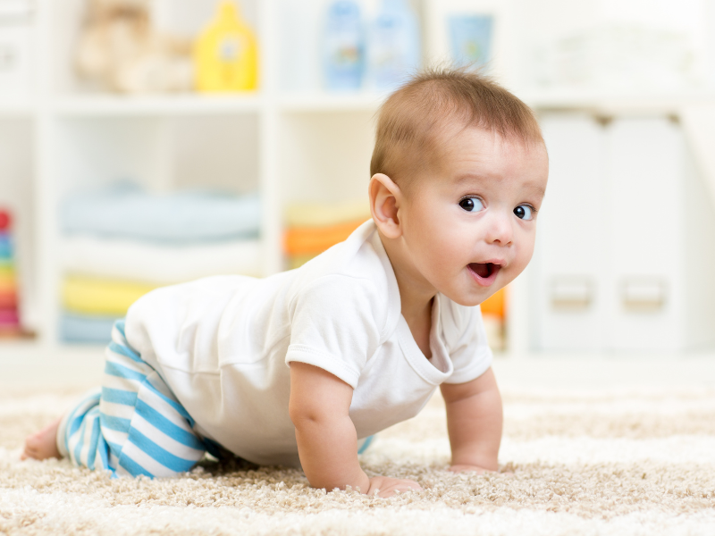 Happy baby enjoying clean carpet after spring carpet cleaning Sunshine Coast