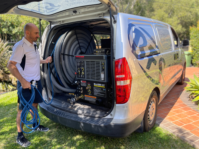 Technician performing professional steam carpet cleaning Sunshine Coast